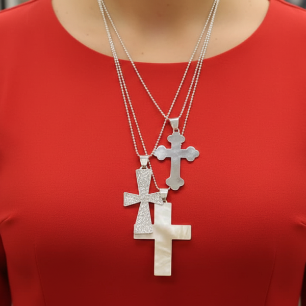 3 sterling silver necklaces with 3-sized crosses on red dress